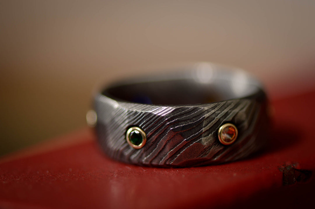 Infinity Ring, Gold, Dark Damascus Steel, & Gemstones